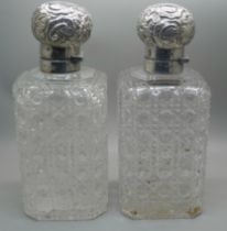 A pair of Victorian silver topped glass decanters, with hinged tops and inner stoppers, London 1890