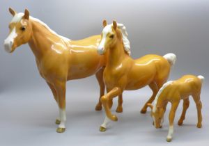 Three Beswick Palomino horses, one ear on middle sized horse restored