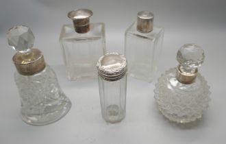 Five silver topped/mounted dressing table bottles, one with continental marked, one top dented