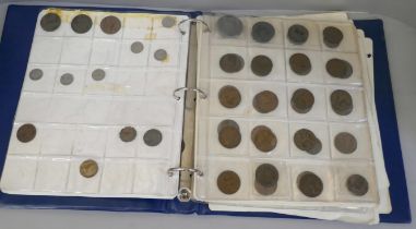 An album of British and foreign coins including a 1797 cartwheel penny, some silver coins, Queen