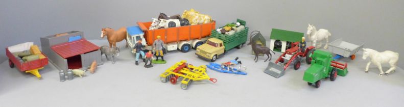 A collection of farmyard models and vehicles, animals, etc.