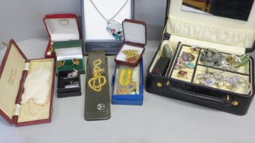 A jewellery box with a quantity of costume jewellery, darts pendant, bracelet, brooches, etc.