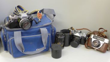 An Olympus OM10 camera with accessories and camera bag, a Peacemaker camera, a Zenit camera and
