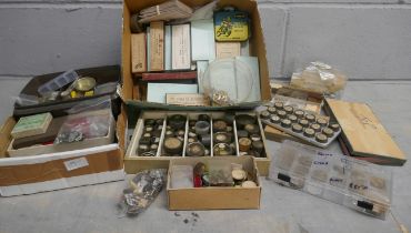 Two boxes of watch materials including main springs, crowns, rotor wheels, etc. **PLEASE NOTE THIS