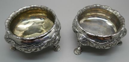 A pair of Georgian silver salt cellars, worn London mark, underside bears crest, 344g