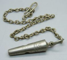 A vintage Birmingham Police 538 Whistle on a metal chain.