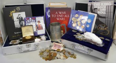 A collection of coins in two aluminium cases; uncirculated coin sets, commemorative coins in cases