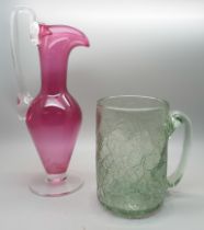 A cranberry glass ewer/vase and a crackle glass mug