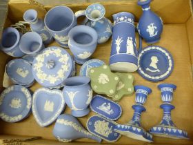 A box of Wedgwood Jasperware including a pair of dark blue candlesticks, jug and vase