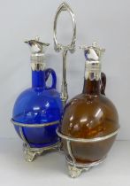 A pair of oil bottles with plated tops, blue and brown glass, on a plated stand