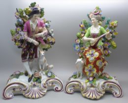 A pair of porcelain bocage detail figures with gold anchor marks, 22cm