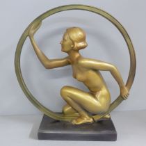 An Art Deco style lady in ring (hoop girl) figure on base, after Leonardi, 29cm