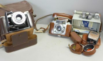 An Agfa Record folding camera, one other Agfa camera and camera accessories