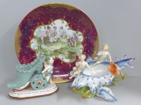 A continental wall plaque, a posy vase with cherubs and a German porcelain cherub shoe posy holder