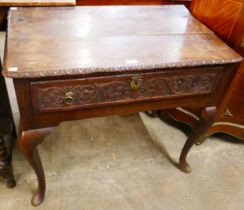 A George II carved oak single drawer side table