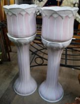 Two pink and white ceramic jardinieres on stands