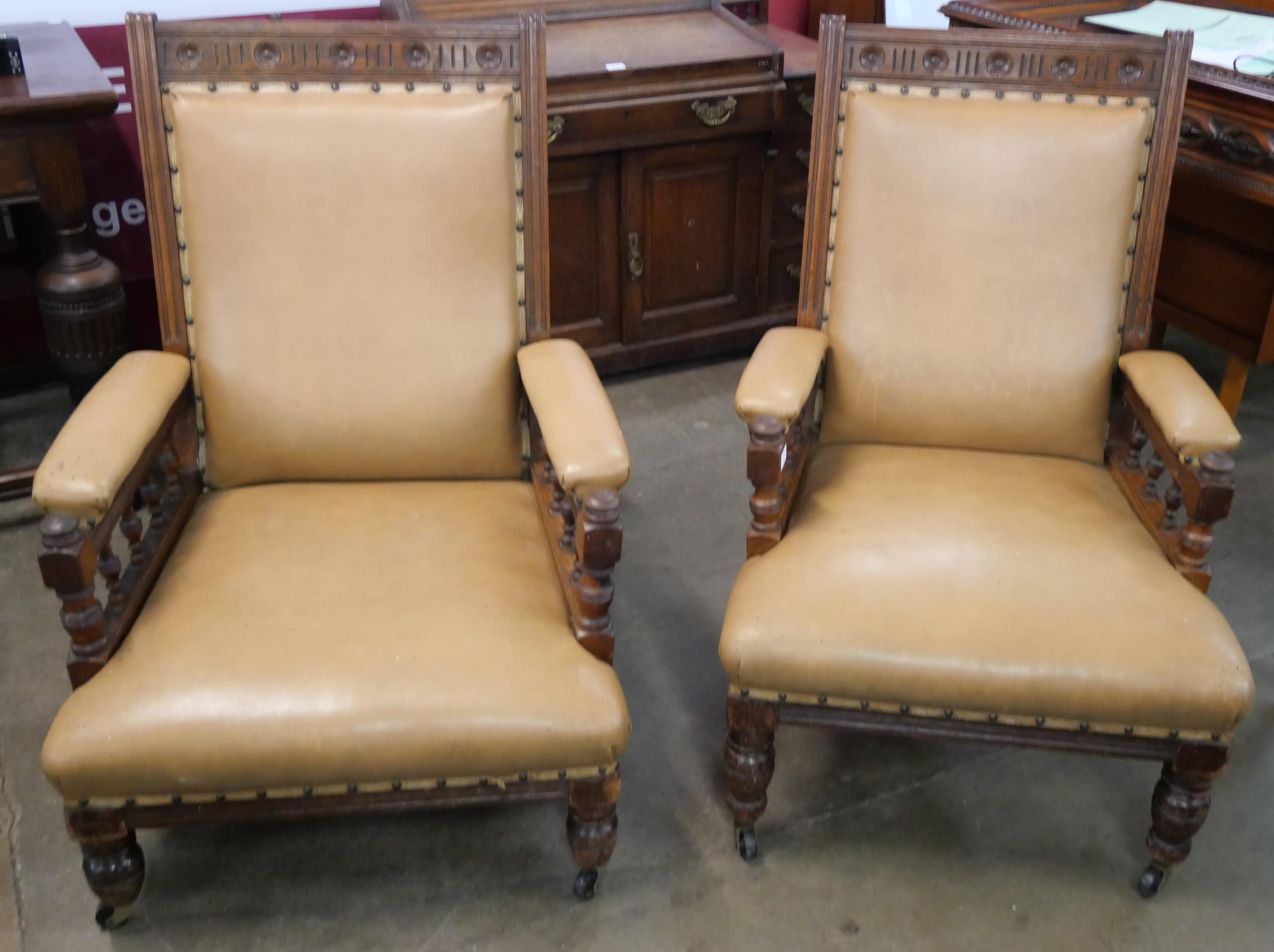 A pair of Victorian Aesthetic Movement carved oak lady's and gentleman's armchairs