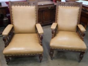 A pair of Victorian Aesthetic Movement carved oak lady's and gentleman's armchairs
