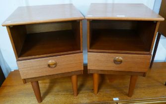 A pair of teak bedside cabinets