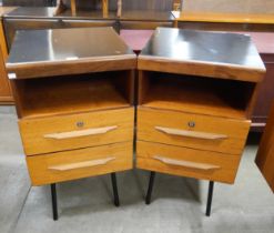 A pair of teak bedsides chests on black metal legs