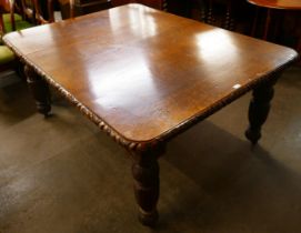 A Victorian carved oak extending dining table
