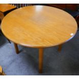 A circular teak dining table