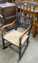 A Victorian elm and rush seated rocking chair