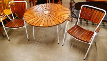 A Danish Daneline teak sunburst and white tubular metal table and two chairs