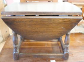 An oak drop leaf occasional table