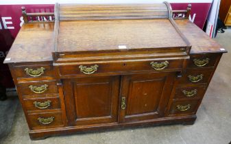 A late Victorian oak tambour roll top bankers desk