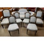 A Victorian ebonised, amboyna and blue fabric upholstered seven piece salon suite, set with Wedgwood