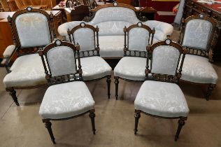 A Victorian ebonised, amboyna and blue fabric upholstered seven piece salon suite, set with Wedgwood