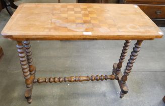 A Victorian inlaid walnut stretcher table