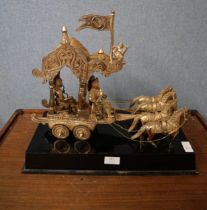 A Far Eastern white metal centrepiece, four horses pulling figures in a carriage