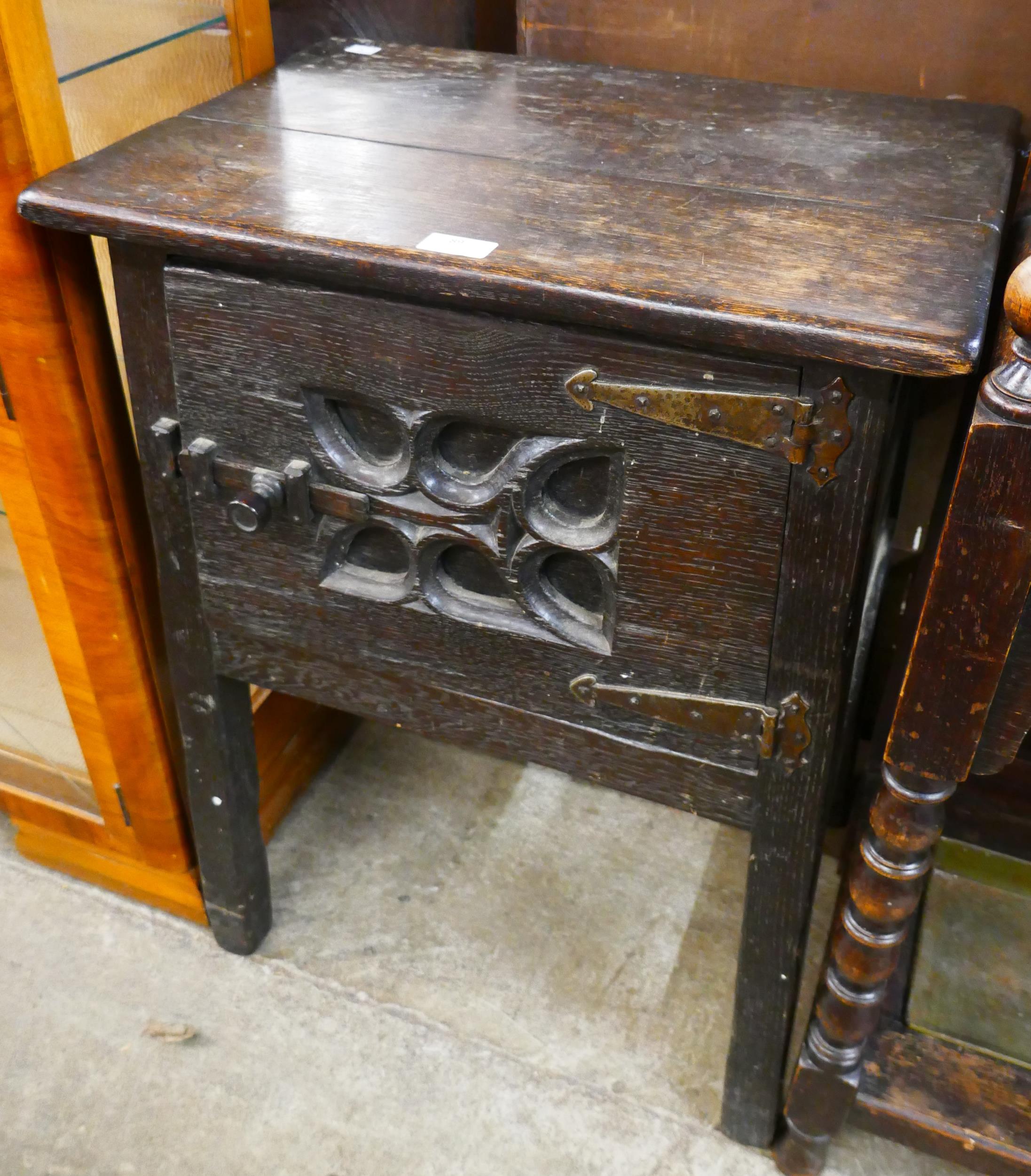 An Elizabethan Revival carved oak credence cupboard