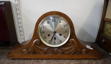 An early 20th Century carved oak mantel clock