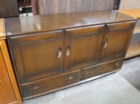 An Ercol Golden Dawn elm Windsor sideboard