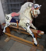 A vintage dapple grey rocking horse