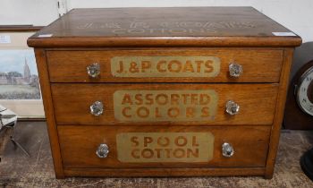 A counter top haberdashery shop cabinet, bearing J&P Coats Cottons inscription