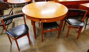 A Nathan teak circular extending table and chairs