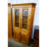 A Victorian style carved pine freestanding corner cabinet