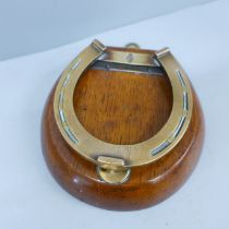 A Victorian oak and brass horseshoe paper clip