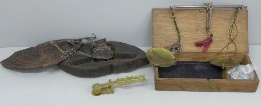 Two sets of opium/apothecary scales in wooden boxes, one box hand carved in the shape of a fish, and