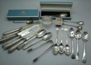 Six silver handled butter knives, a collection of Georgian and later silver spoons, a silver stamp