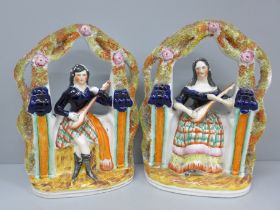 A pair of 19th Century Staffordshire flatback figures of seated musicians, both with hairline