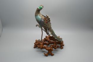 A Chinese silver gilt and enamelled model of a peacock, one amber enamelled piece missing, affixed