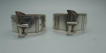 A pair of Victorian silver buckle detail napkin rings, Birmingham 1891, Siege of Mafeking