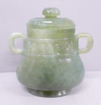 An oriental lidded jade two-handled covered vessel, one handle repaired, 11cm