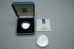 A 1990 silver proof one pound coin and a 1995 9999 silver proof 1oz Maple 5 Dollars