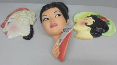 Two English ceramic face plaques, crazed, and a plaster face plaque of a South East Asian girl
